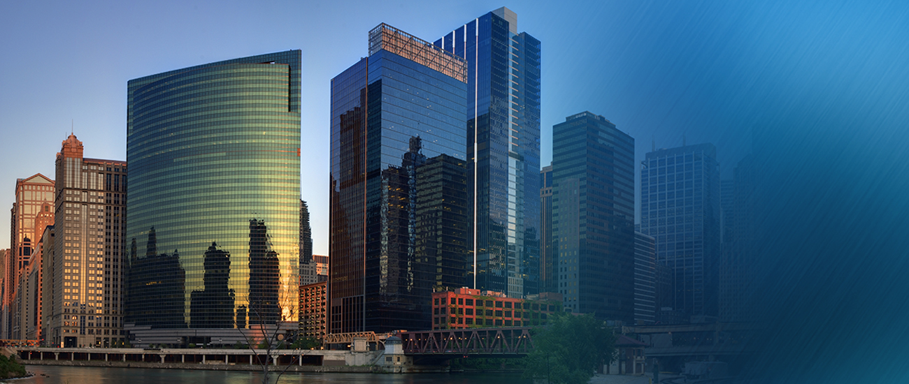 Modern city skyline reflecting the sunset on a riverfront, showcasing a mix of architectural styles.